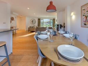 a dining room and living room with a table and chairs at Lodge 53 Una in Carbis Bay +43 photos