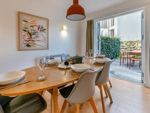 a dining room with a wooden table and chairs at Lodge 53 Una in Carbis Bay