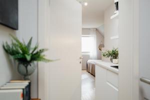 a living room with a door leading to a bedroom at MAISON ART Appartements - Objekt 94080 in Warnemünde