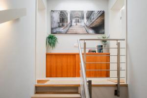 a staircase in a hallway with a painting on the wall at MAISON ART Appartements - Objekt 94080 in Warnemünde