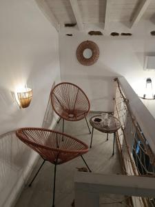 a staircase with two chairs and a table at Annousio 's house in Dhriopís