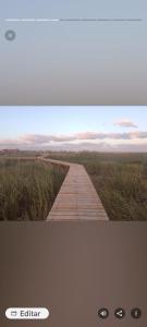 a picture of a boardwalk in the middle of a field at Irupecita Refugio Isleño in Victoria