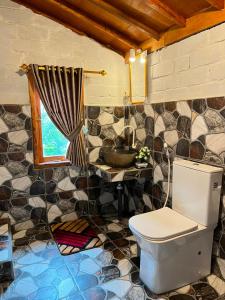 a bathroom with a toilet and a sink at Fuma Bungalow Tetebatu in Tetebatu +17 photos