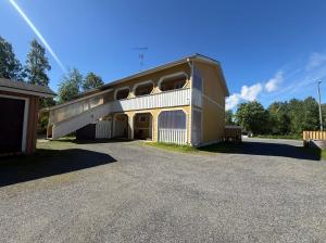 a building with a parking lot in front of it at Loft house Karihaara in Kemi