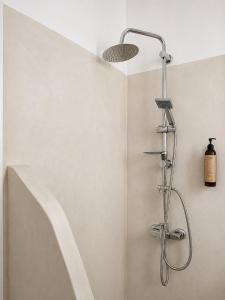 a shower with a shower head in a bathroom at Fikas Hotel in Naxos Chora +102 photos