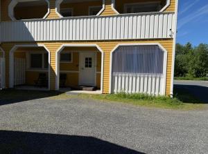a yellow and white building with a garage at Loft house Karihaara in Kemi +4 photos