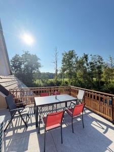 a patio with a table and chairs on a balcony at Apartment House Belca in Preddvor