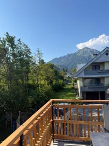 a balcony with a view of a house and mountains at Apartment House Belca in Preddvor +47 photos