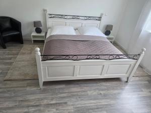 a bedroom with a white bed with a metal frame at Quiet Place in Achern
