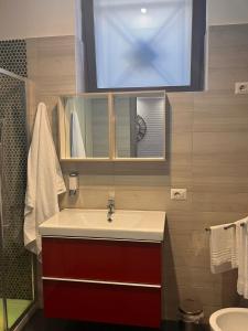 a bathroom with a sink with a mirror and a window at Urban Home in Pompei +59 photos