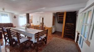 a dining room with a table and chairs in a room at Casa de vacanta Bulz in Bulz