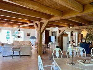 a living room with wooden ceilings and a living room at Landhaus Hüttblek in Hüttblek