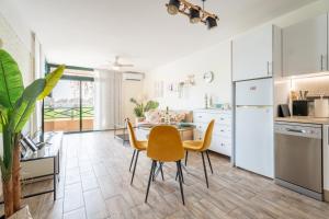 a kitchen and dining room with a table and chairs at Paz Ocean View, 2 Air Conditioners, Wifi, Heated pool in San Miguel de Abona +142 photos