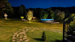 a backyard with a hot tub in the grass at Oasis Acropolis Serres Parking EV Next to Center in Serres