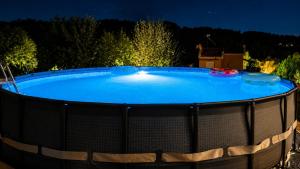 a large swimming pool in a backyard at night at Studio Acropolis Serres Parking EV Next to Center in Serres