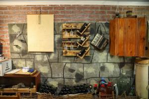 a brick wall with a bunch of wine bottles on it at Guest House Mercury in Khulo
