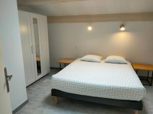 a bedroom with a bed with two pillows on it at Domaines des confines in Monteux +81 photos