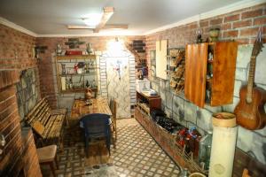 a kitchen with a table and a brick wall at Guest House Mercury in Khulo +18 photos