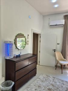 a living room with a dresser and a mirror at Heart of Jerash in Jerash