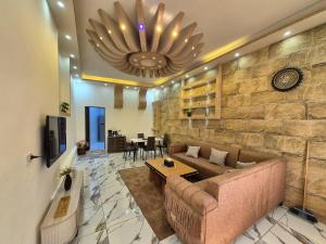 a living room with a couch and a table at Heart of Jerash in Jerash