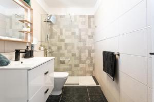 a bathroom with a toilet and a sink at Paz Ocean View, 2 Air Conditioners, Wifi, Heated pool in San Miguel de Abona