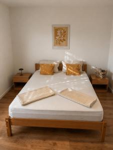 a large white bed with two pillows on it at Apartman Šarić in Neum