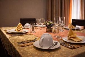 a table with plates and utensils on top of it at Hotel Murex in Brazzaville