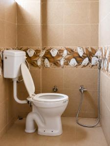 a bathroom with a toilet and toilet paper rolls at Hotel Tiger Paradise in Mahirāvani