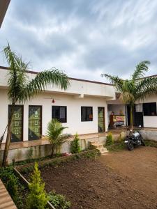 a building with a motorcycle parked in front of it at Hotel Tiger Paradise in Mahirāvani