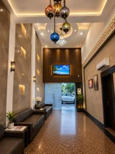 a lobby of a hotel with couches and a television at Mb View taj in Tājganj