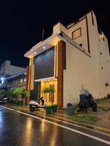 a building on the side of a street at night at Mb View taj in Tājganj