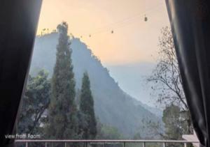 a view of a mountain from a bus window at Urbane Haauz in Pelling +3 photos