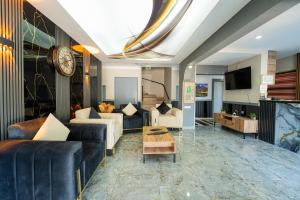 a living room with a couch and a table at Kutberk Hotel Kemer in Kemer