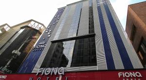 a tall building with a sign on the side of it at Hotel Fiona in Seoul