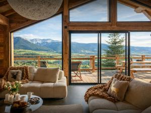 a living room with couches and a view of mountains at Chalet Càlid - OVO Network in Font-Romeu