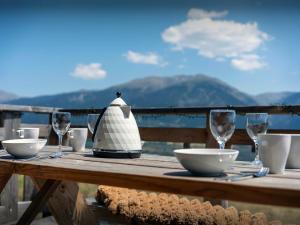 a wooden table with glasses and a kettle on it at Chalet Càlid - OVO Network in Font-Romeu +22 photos