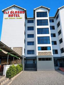 a building with a sign for a hotel at J & J Olosho Hotel in Kiserian