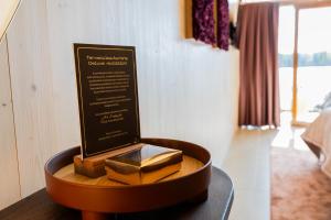 a plaque on a table in a room at Bella Lake Resort in Kuopio +35 photos