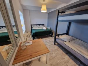 a room with two bunk beds and a table at Zielona Przystań in Manasterz +98 photos