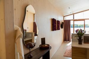 a dressing room with a mirror on the wall at Bella Lake Resort in Kuopio