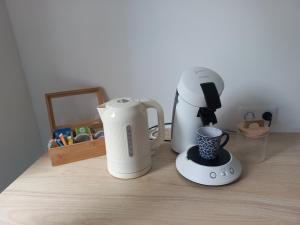 a blender and a coffee maker on a counter at L'Hirondelle in Fourges