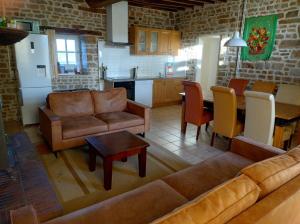 a living room with a couch and a table at Orbigny Vakantiewoningen in Saint-Pierre-la-Vieille