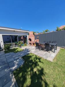 a patio with a table and chairs in a yard at The Cube in Sibiu +8 photos