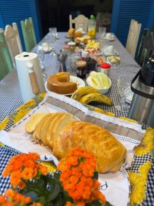 a table with two loaves of bread on it at Pousada Tiê-Sangue in Iporanga +39 photos