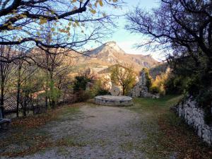 a stone bench with a mountain in the background at Le chèvrefeuille in Sahune