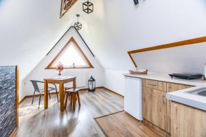 a kitchen and dining room with a table and a window at Willa Pod Wierchem in Bukowina Tatrzańska