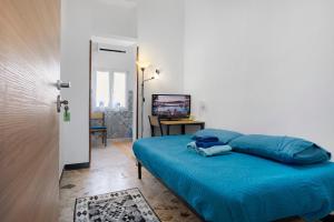 a bedroom with a blue bed in a room at The Nice Bright House in Palermo
