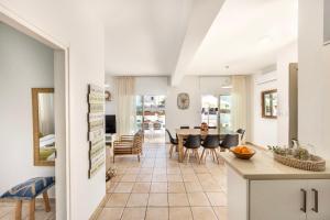 a kitchen and dining room with a table and chairs at Fig Tree Beach villa Three in Protaras