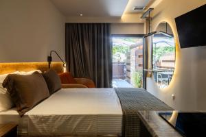 a hotel room with a bed and a balcony at Sylvia Camping & Luxury Suites in Litochoro +212 photos