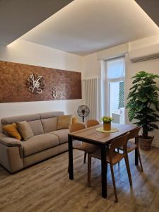 a living room with a couch and a table at Il Nido del Bernina 2 minuti dalla stazione Clessidra2 bilocale in Tirano +53 photos